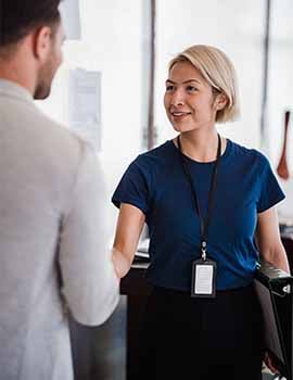 Two professionals shaking hands in an office setting