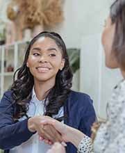 Two professional women shaking hands, image by Pexels, George Milton